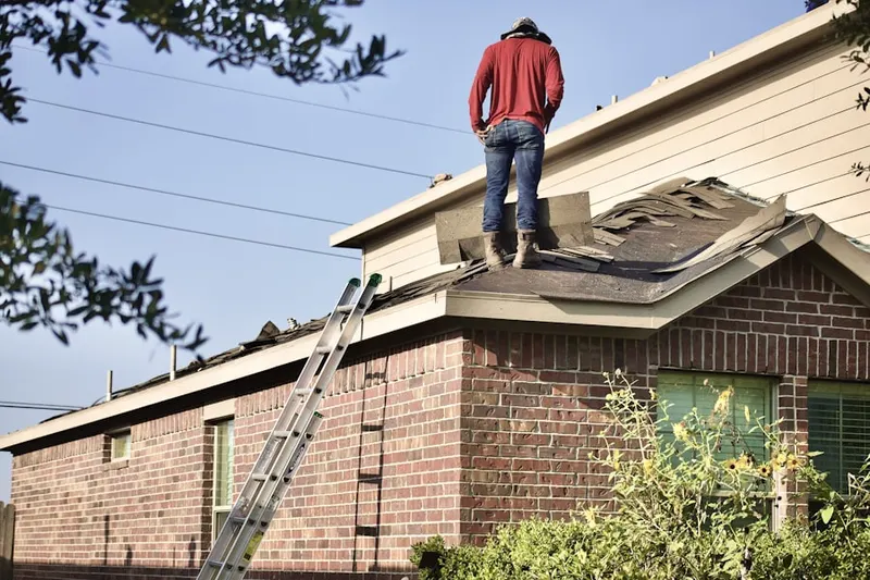 Professional roofer working on a residential roof in St. Francis